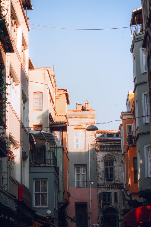 Free Sunlit view of a historic street with colorful buildings and classic architecture. Stock Photo