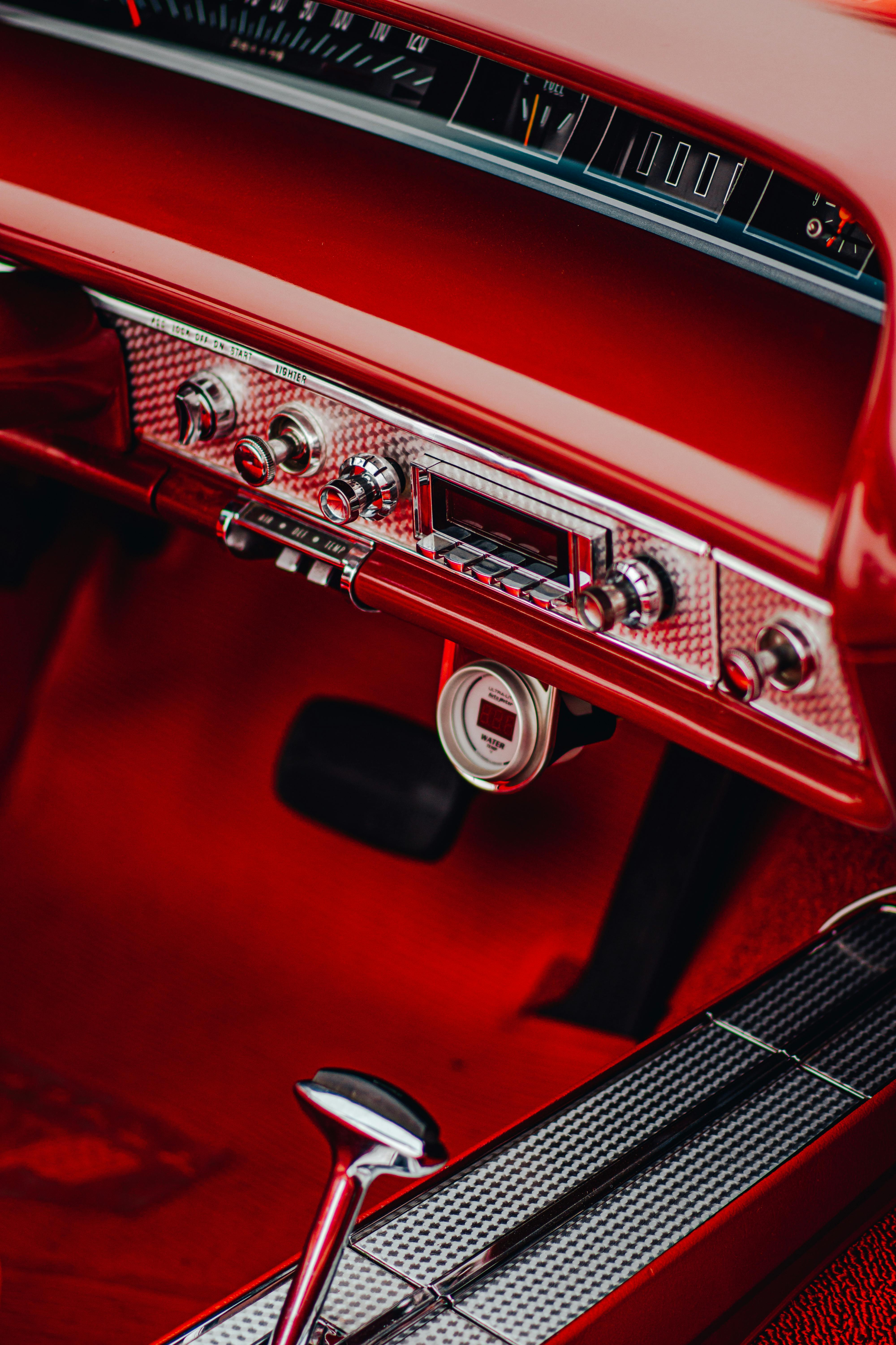 Close-up of a vintage red car interior with detailed dashboard in Los Angeles.