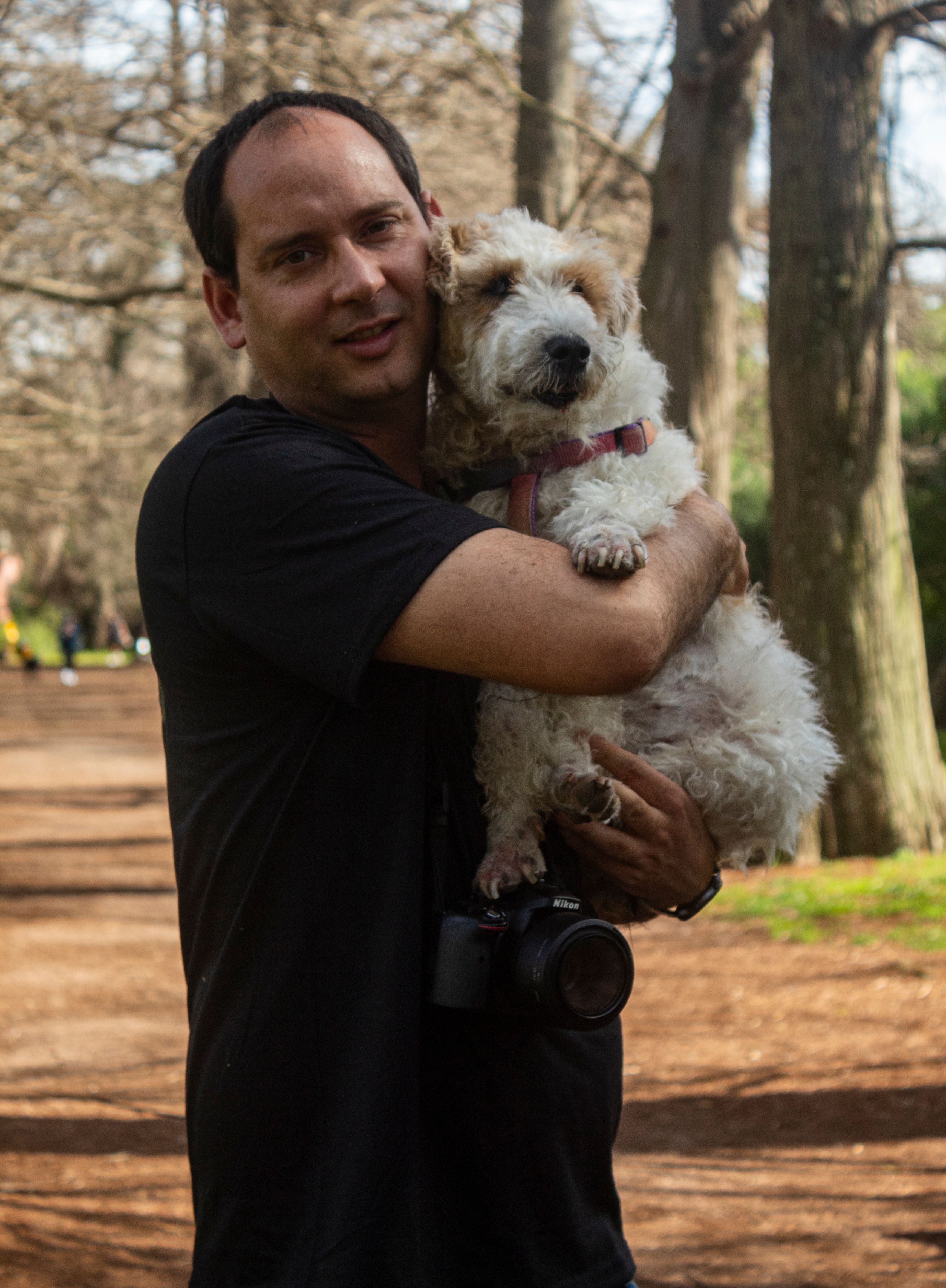 A man and his dog enjoying a sunny day outdoors in Montevideo, Uruguay.