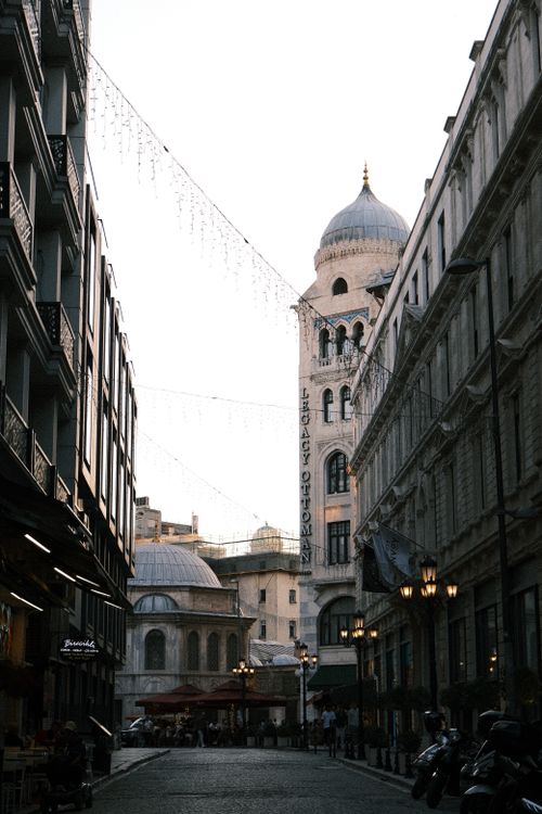Free Charming European street view with historic architecture and ambient evening light. Stock Photo