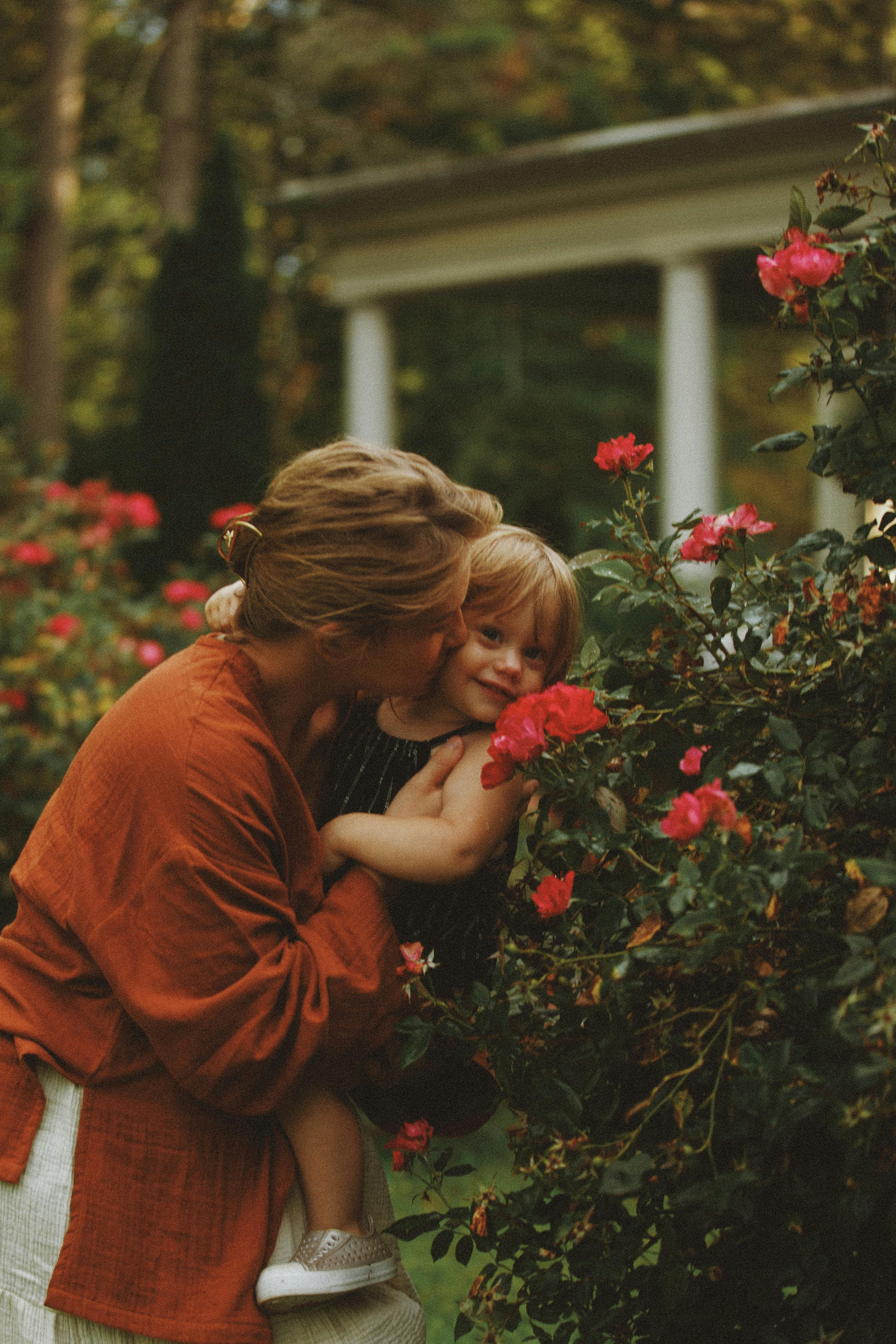 A heartwarming moment of a mother and her child in a blooming garden in Brevard, North Carolina.