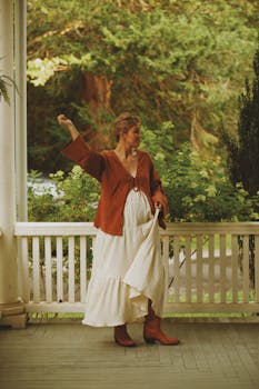 Woman in a bohemian-style cotton maxi dress on a porch in lush surroundings, Brevard, NC.
