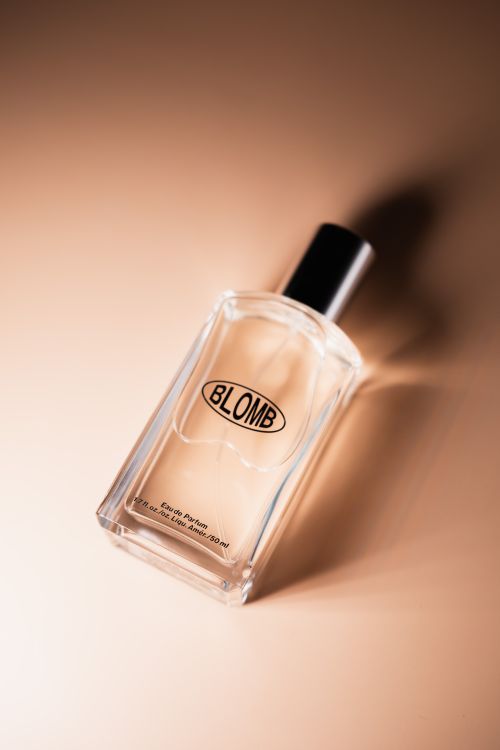 Free A chic glass perfume bottle with elegant shadows on a warm beige surface. Stock Photo