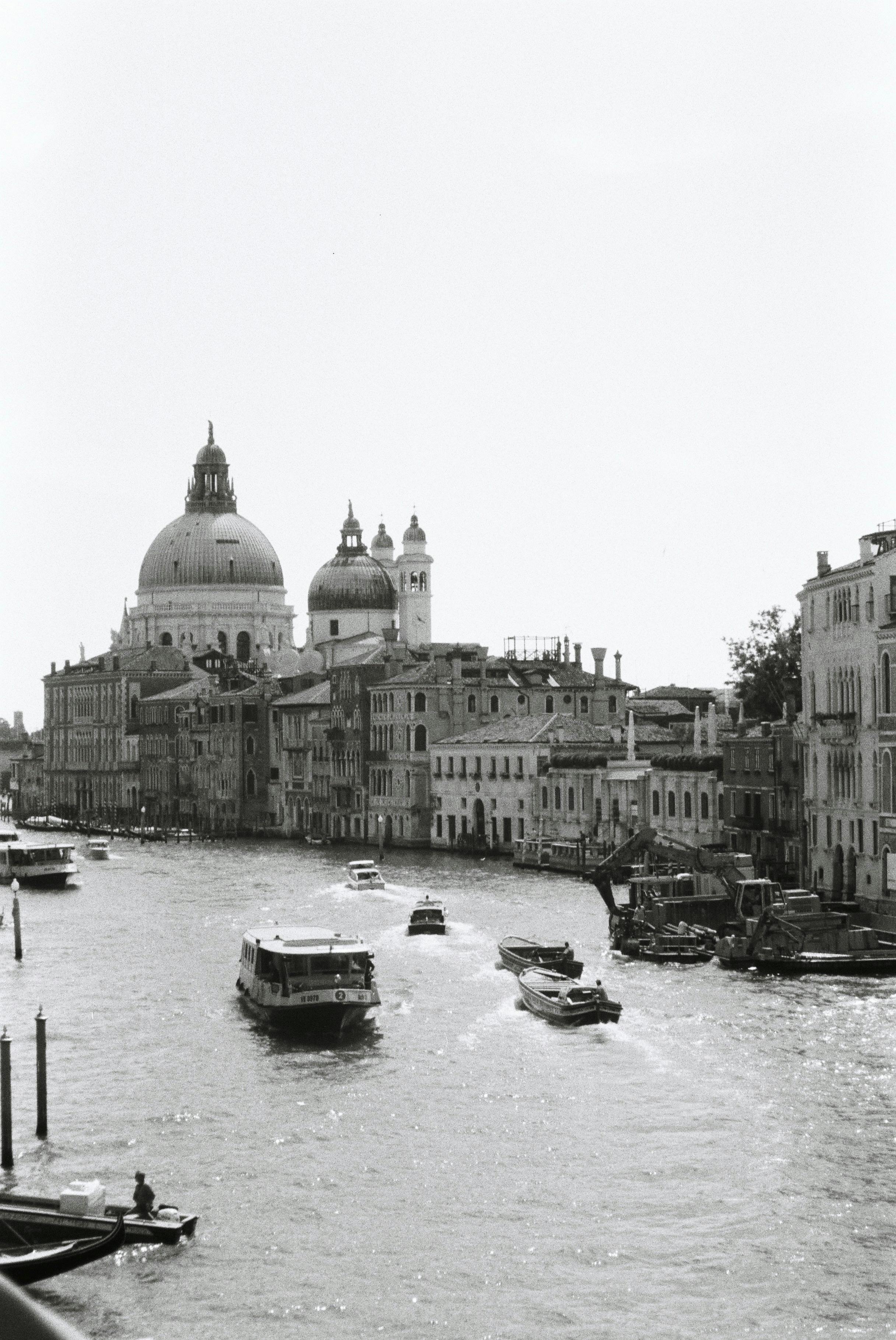 Scenic black and white photo of the Grand Canal in Venice featuring historic architecture and boats.