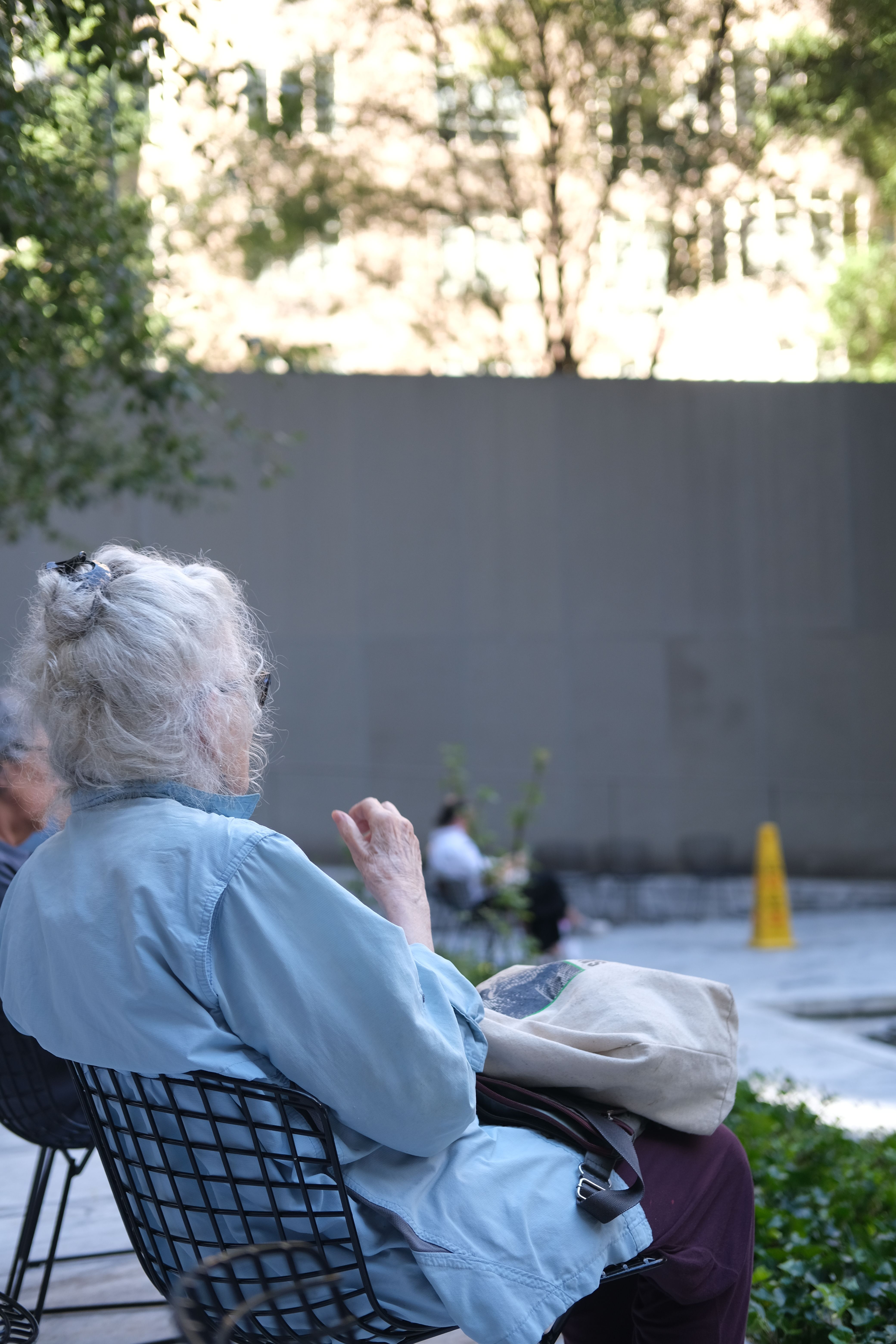 Senior Woman Relaxing in Urban Park Setting · Free Stock Photo