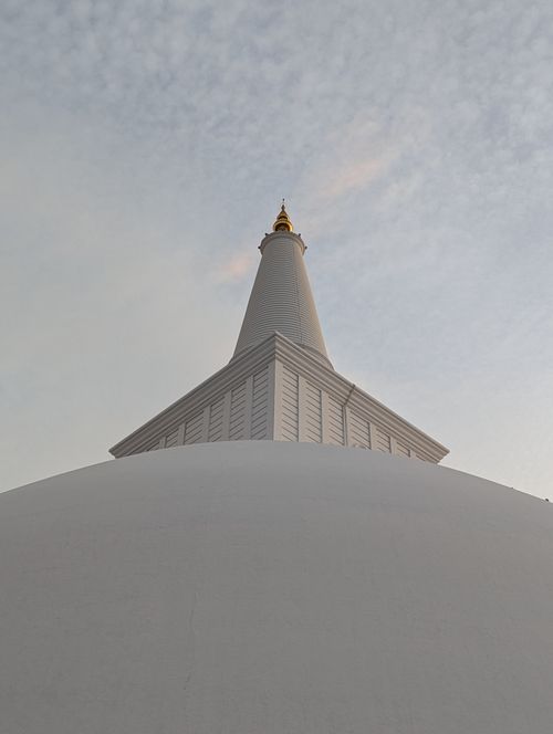 Free A low-angle view of the majestic Ruwanweli Maha Seya at sunset in Anuradhapura, Sri Lanka. Stock Photo