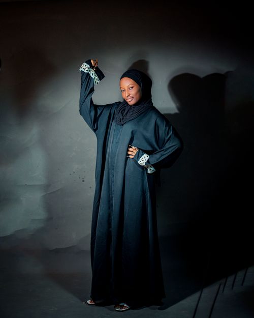 Free Portrait of a woman in traditional attire, exuding confidence and grace, with a dark background. Stock Photo