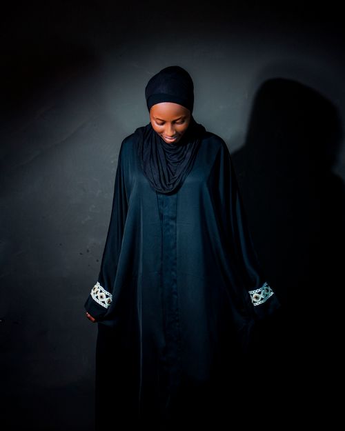 Free Elegant portrait of a woman in a black hijab against a dark background, exuding grace and confidence. Stock Photo