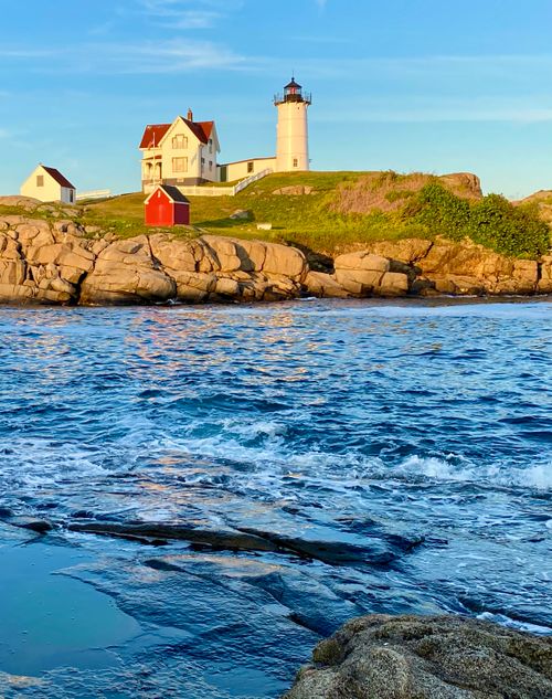 Free Stunning view of Nubble Lighthouse in York, Maine at sunset. Iconic coastal landmark with vivid ocean waves. Stock Photo