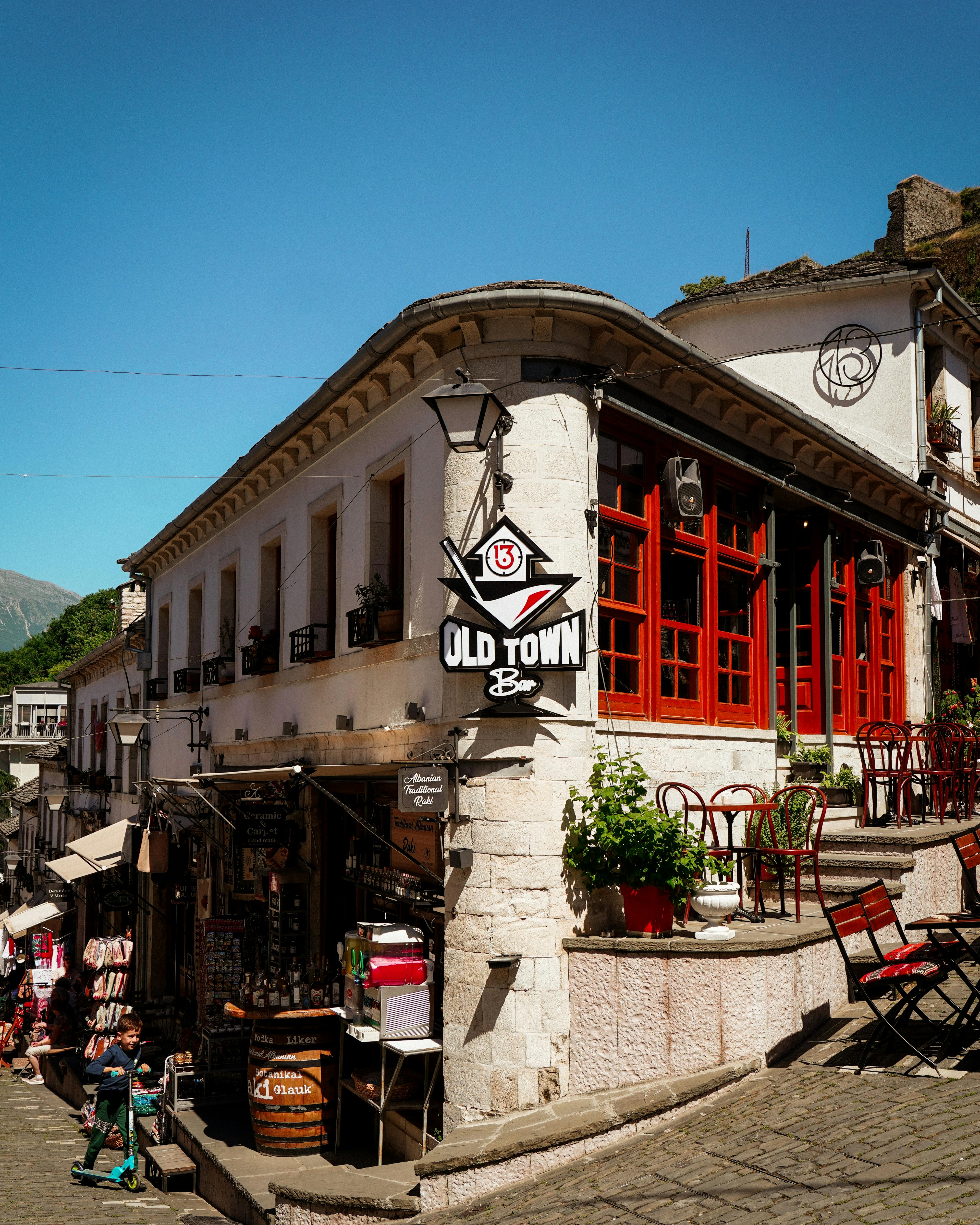 A scenic street view of Gjirokastër's historic architecture and bazaar.
