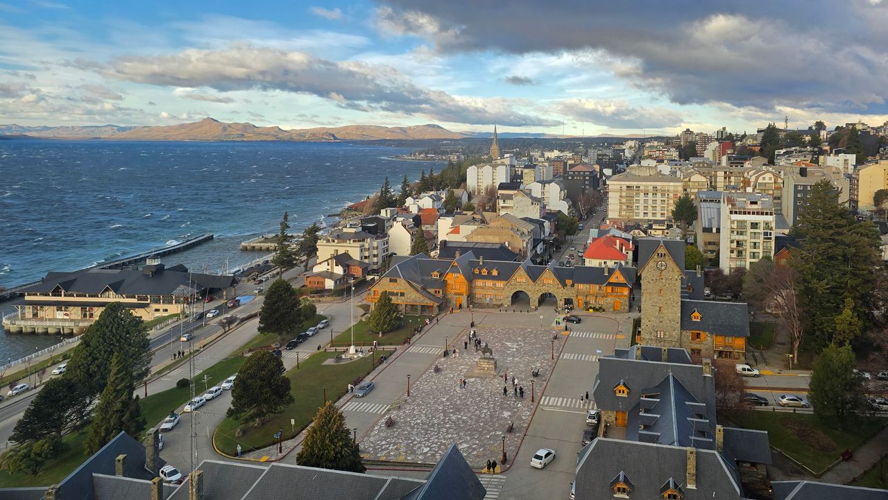 A picturesque aerial view of San Carlos de Bariloche, Argentina showcasing the town and Nahuel Huapi Lake.