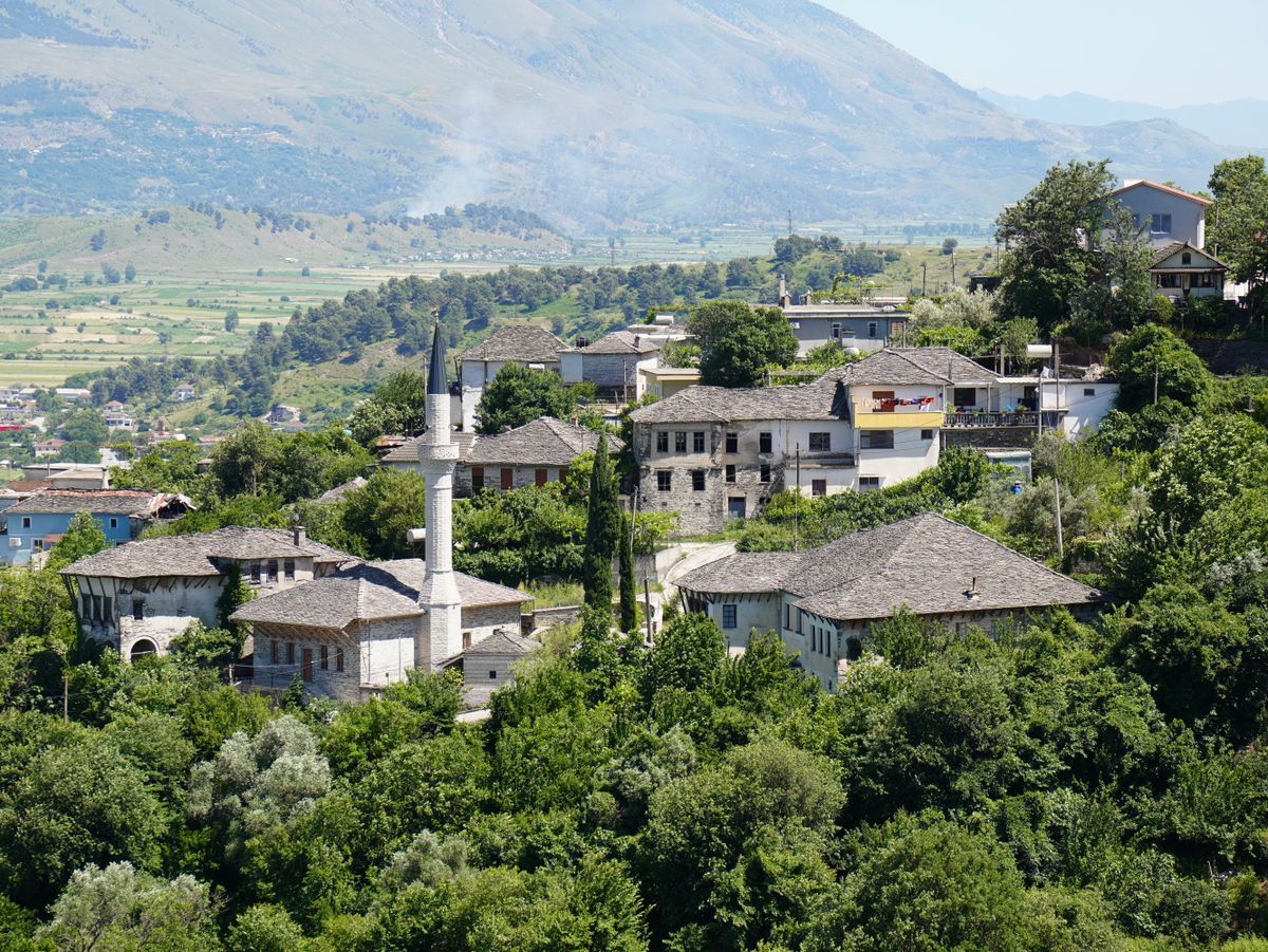 Gjirokastër's stone houses climbing the hillside — Albania's UNESCO "City of Stone."