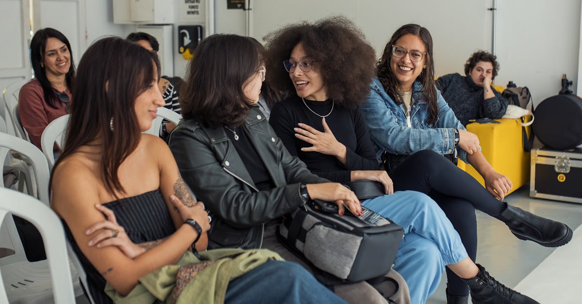 A group of young adults conversing and enjoying a casual indoor setting.
