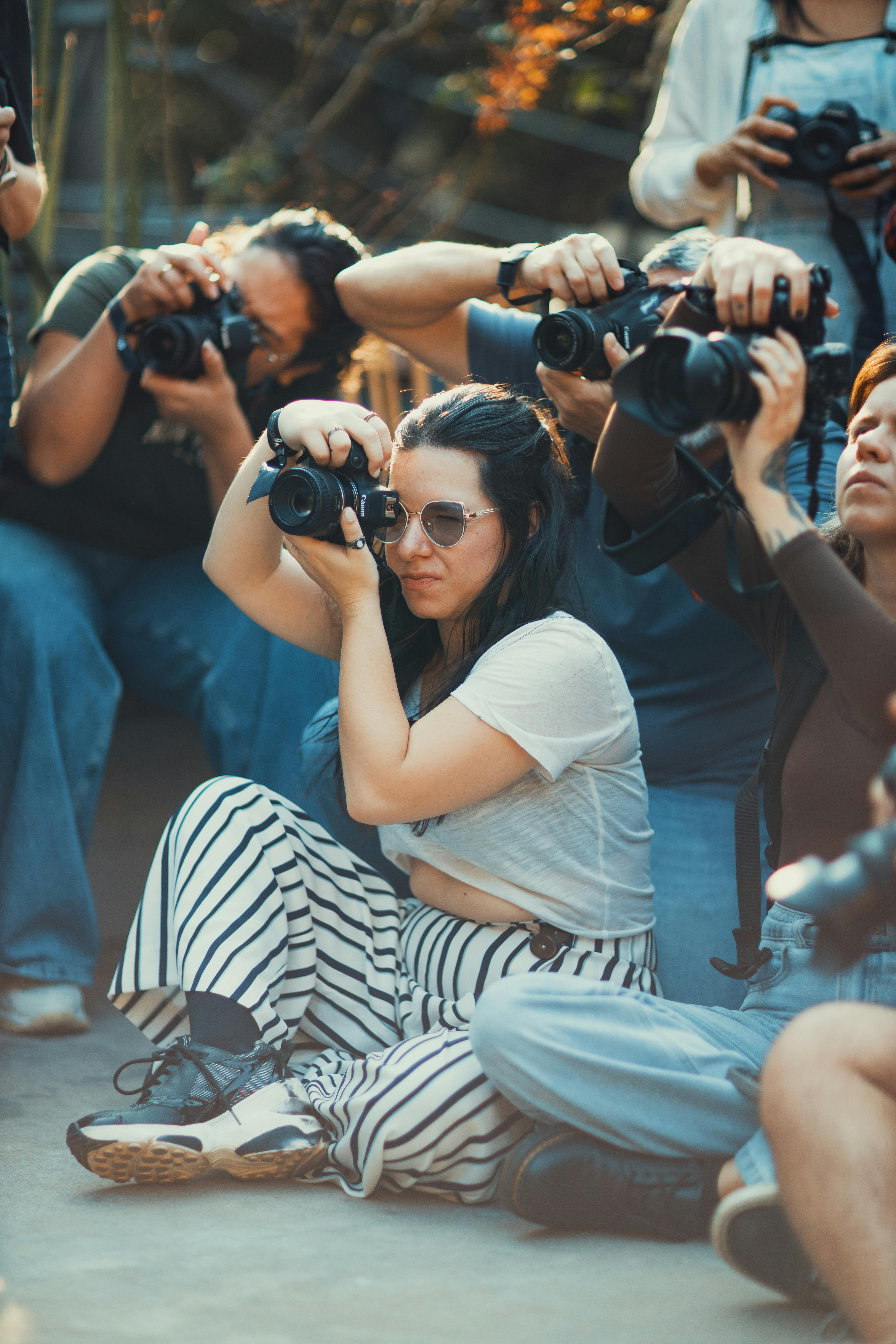 Photographers capturing moments at an outdoor workshop event.