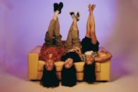 Playful Friends Hanging Upside Down on Couch