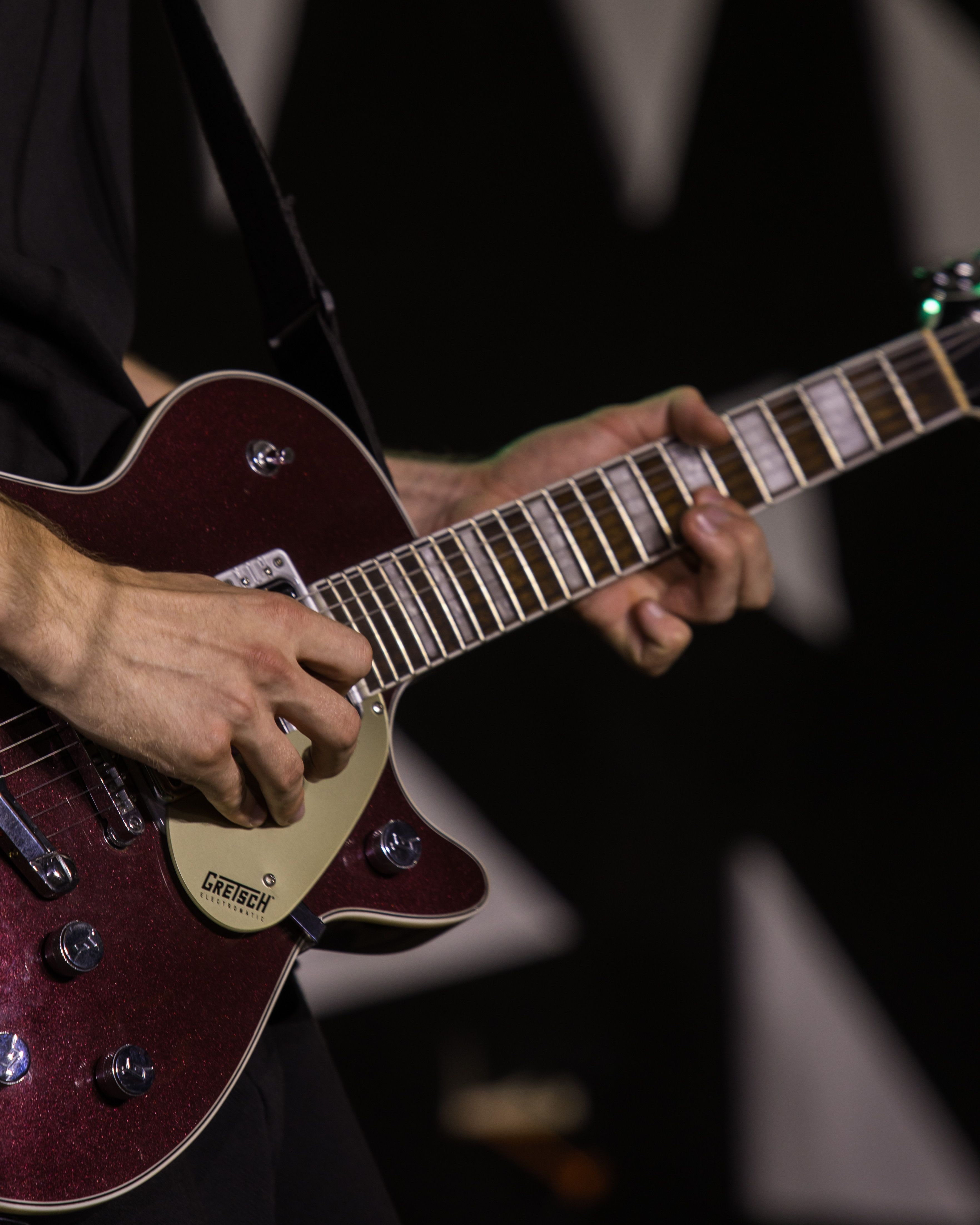 Musician passionately plays a Gretsch electric guitar during a live performance.. musician, passionately, plays