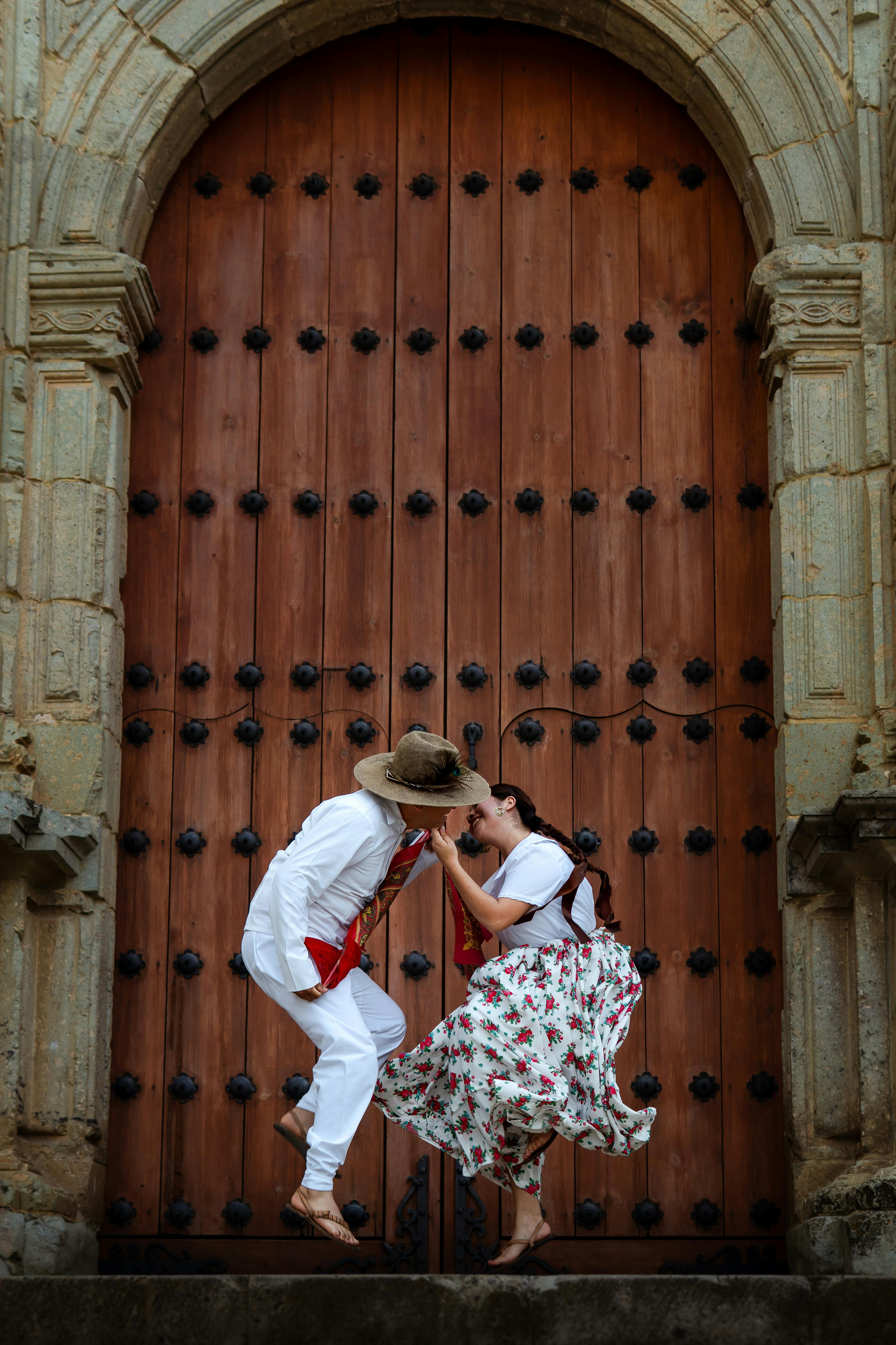 Couple in traditional attire performing a cultural dance in Oaxaca, Mexico.