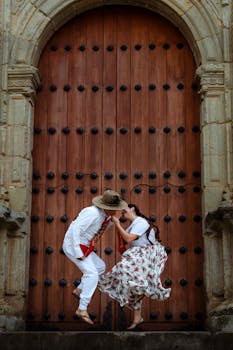 Couple in traditional attire performing a cultural dance in Oaxaca, Mexico.