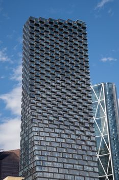 Impressive view of a contemporary skyscraper under a clear blue sky in downtown Calgary. Perfect for cityscape enthusiasts.