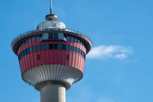 A detailed view of the iconic Calgary Tower set against a bright blue sky.