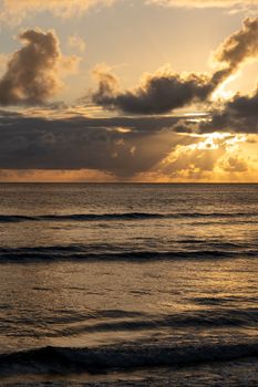 Peaceful sunset view over the ocean in Fiji with stunning cloud formations, capturing the essence of tranquility.