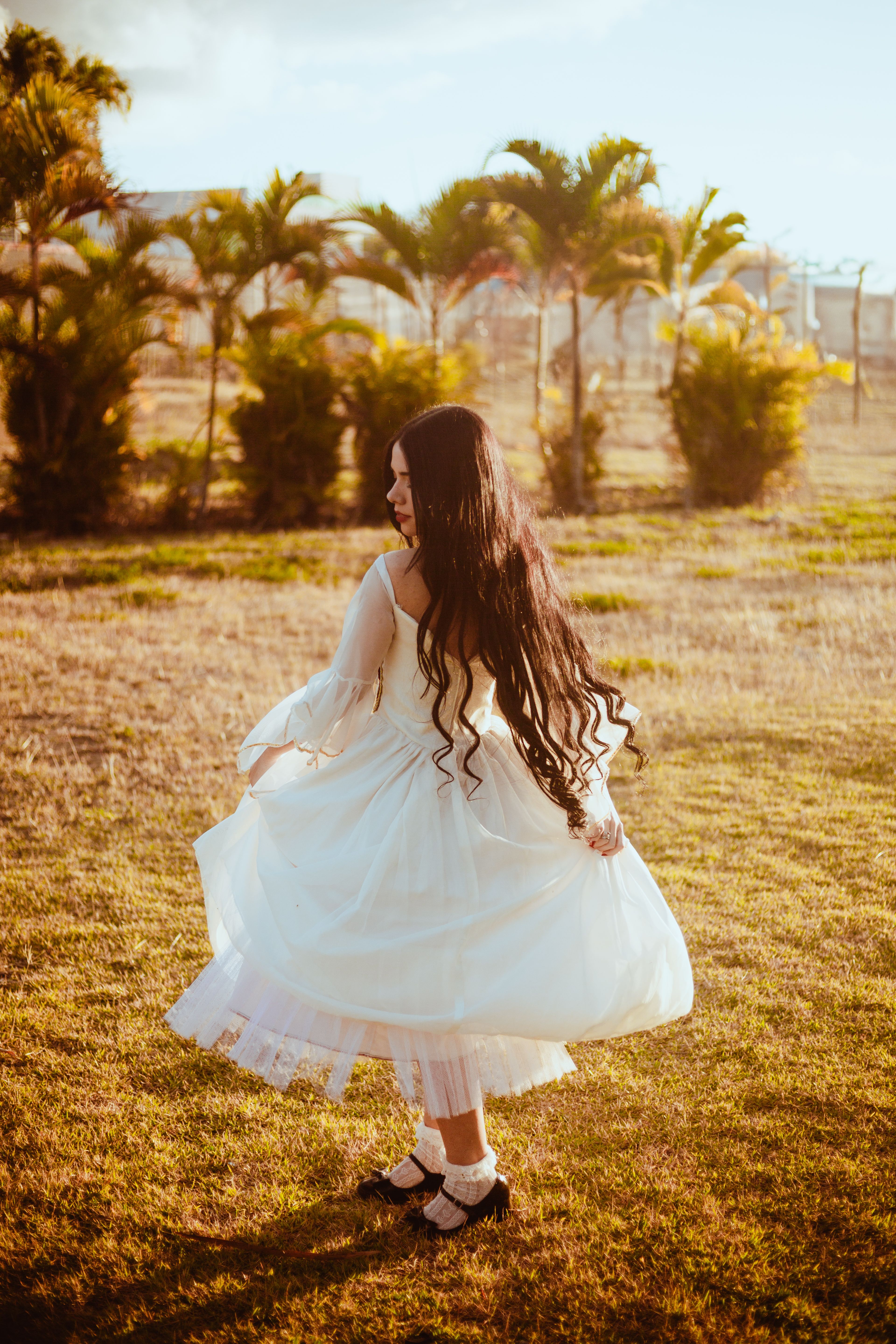 Young Woman Twirling in a White Dress Outdoors Free Stock Photo Young Woman Twirling in a White Dress Outdoors Free Stock Photo