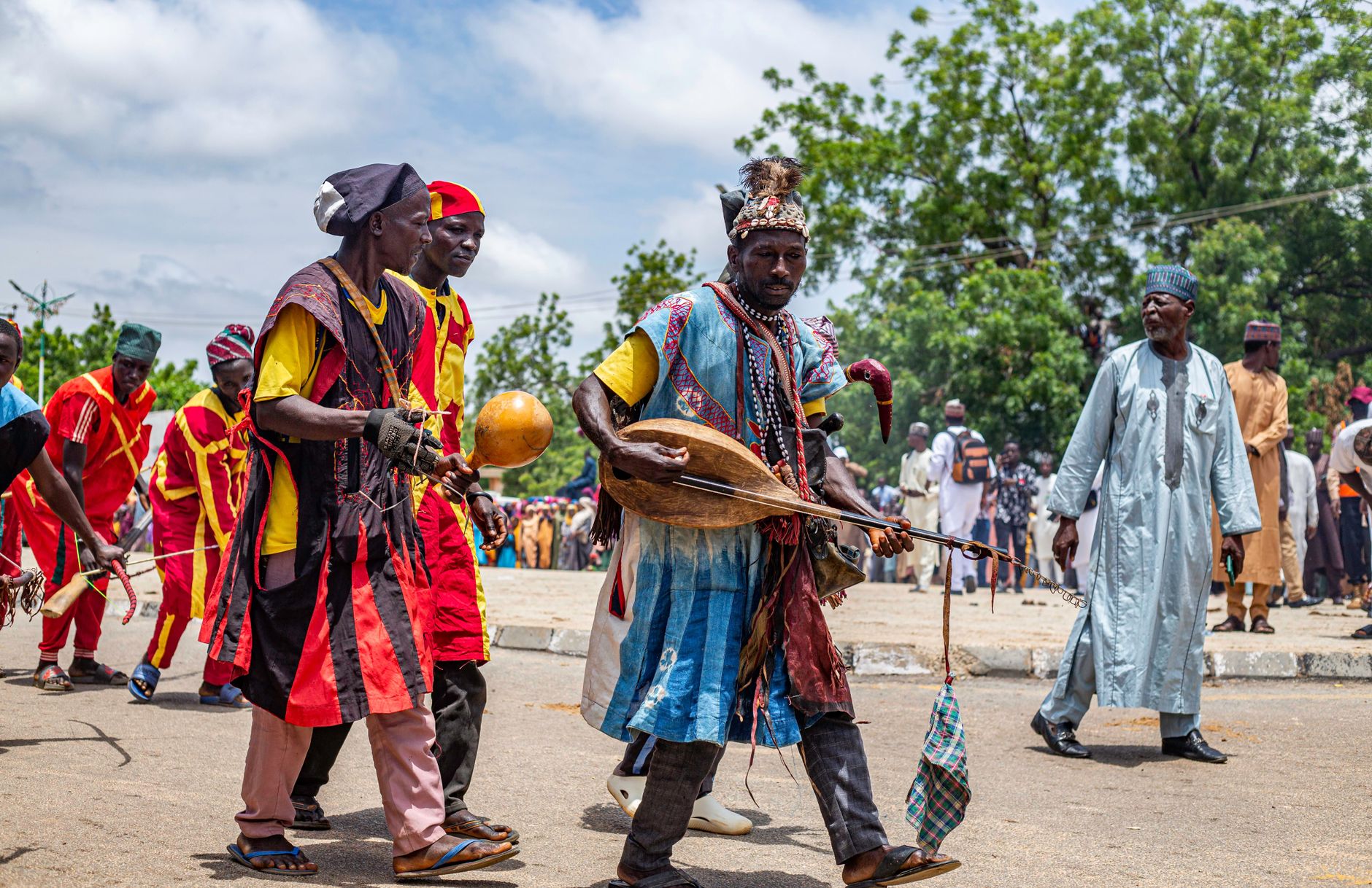 Vibrant street festival in Daura, Nigeria, showcasing traditional African musicians performing.