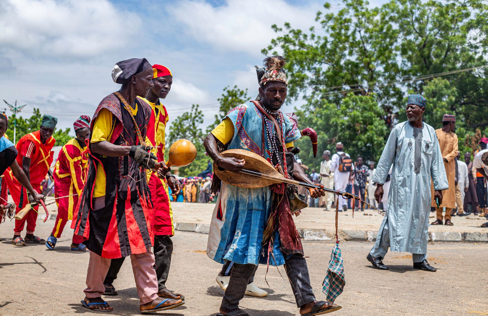Vibrant street festival in Daura, Nigeria, showcasing traditional African musicians performing.