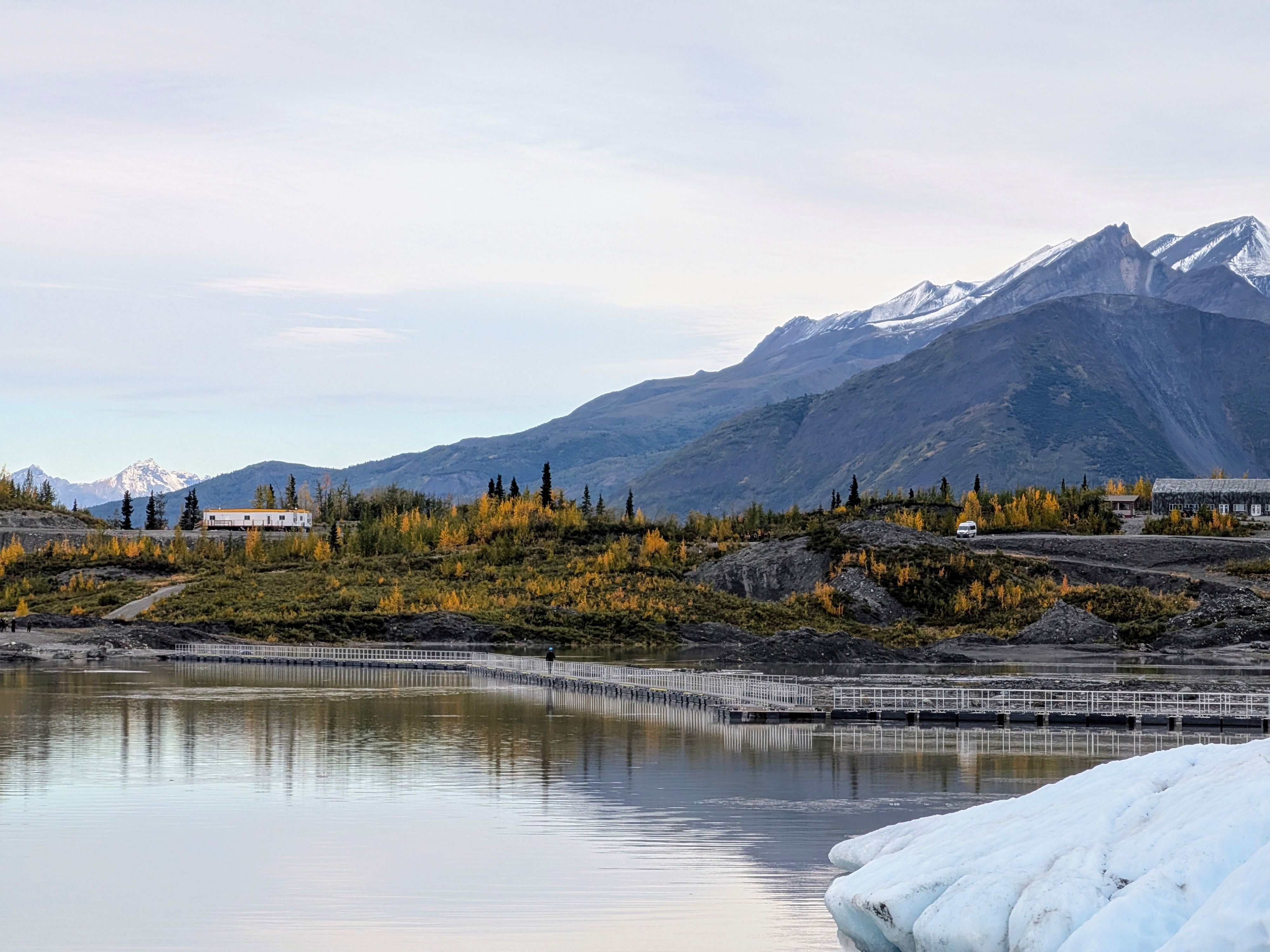 Helicopter and Glacier Paddle Boarding -PRIVATE - A breathtaking view of mountains and lake with reflections, showcasing autumn colors.