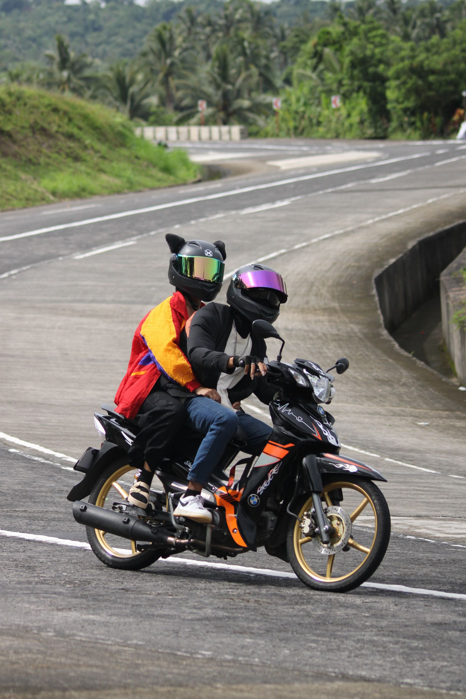 Motorcyclists on a scenic mountain road showing why group size matters on a Ha Giang tour