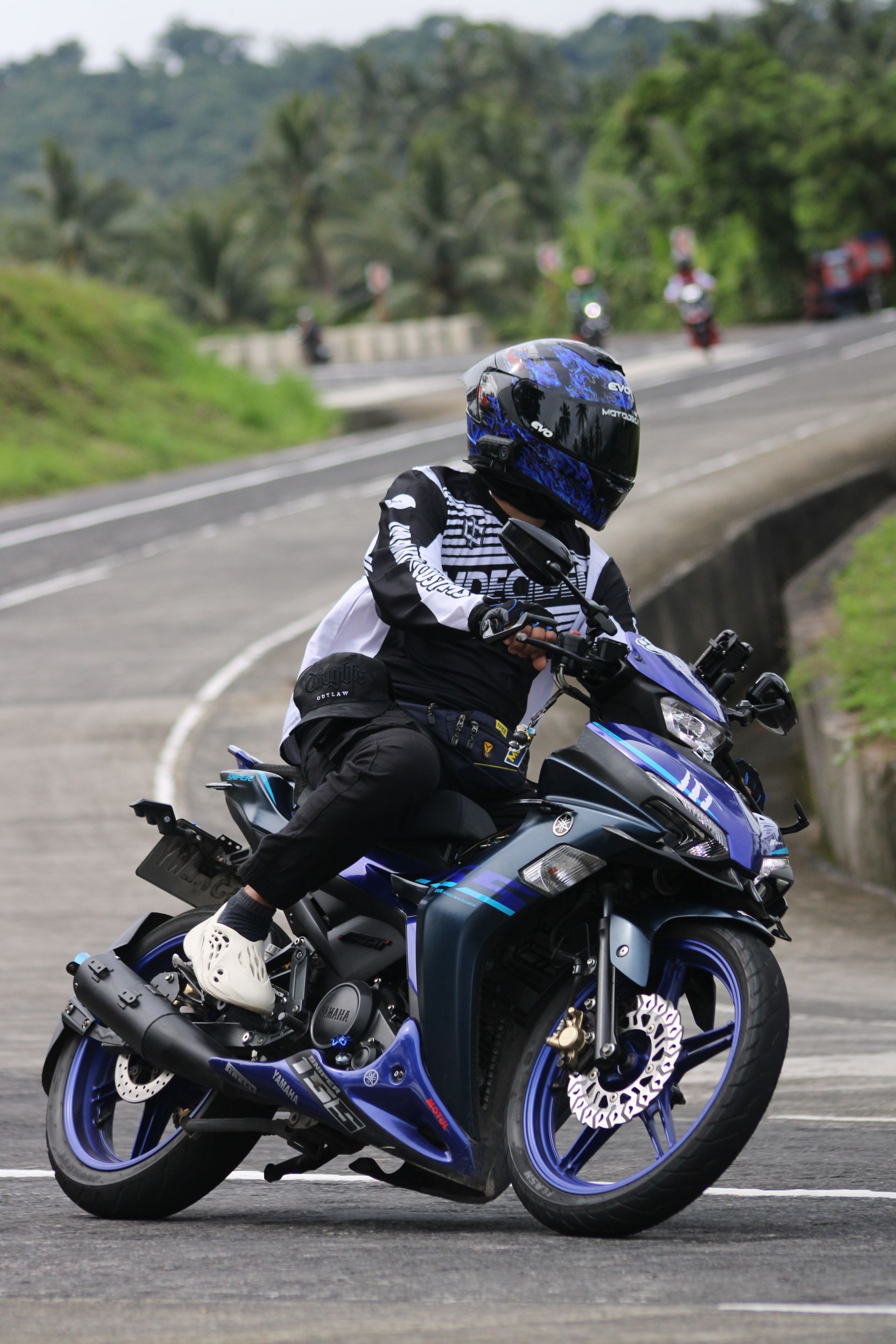 Motorcyclist riding a sport motorcycle on a winding road