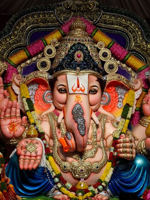 Free Vibrant statue of Hindu deity Ganesha adorned in colorful ornaments and jewelry, symbolizing wisdom. Stock Photo