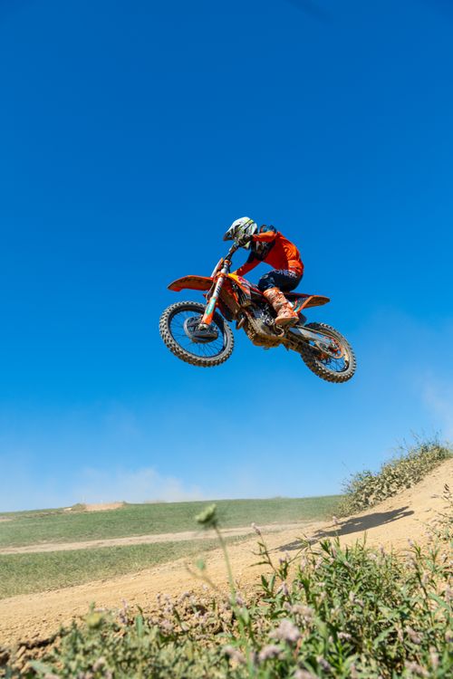 Free Thrilling dirt bike jump on a sunny day in Canonsburg, capturing off-road excitement. Stock Photo