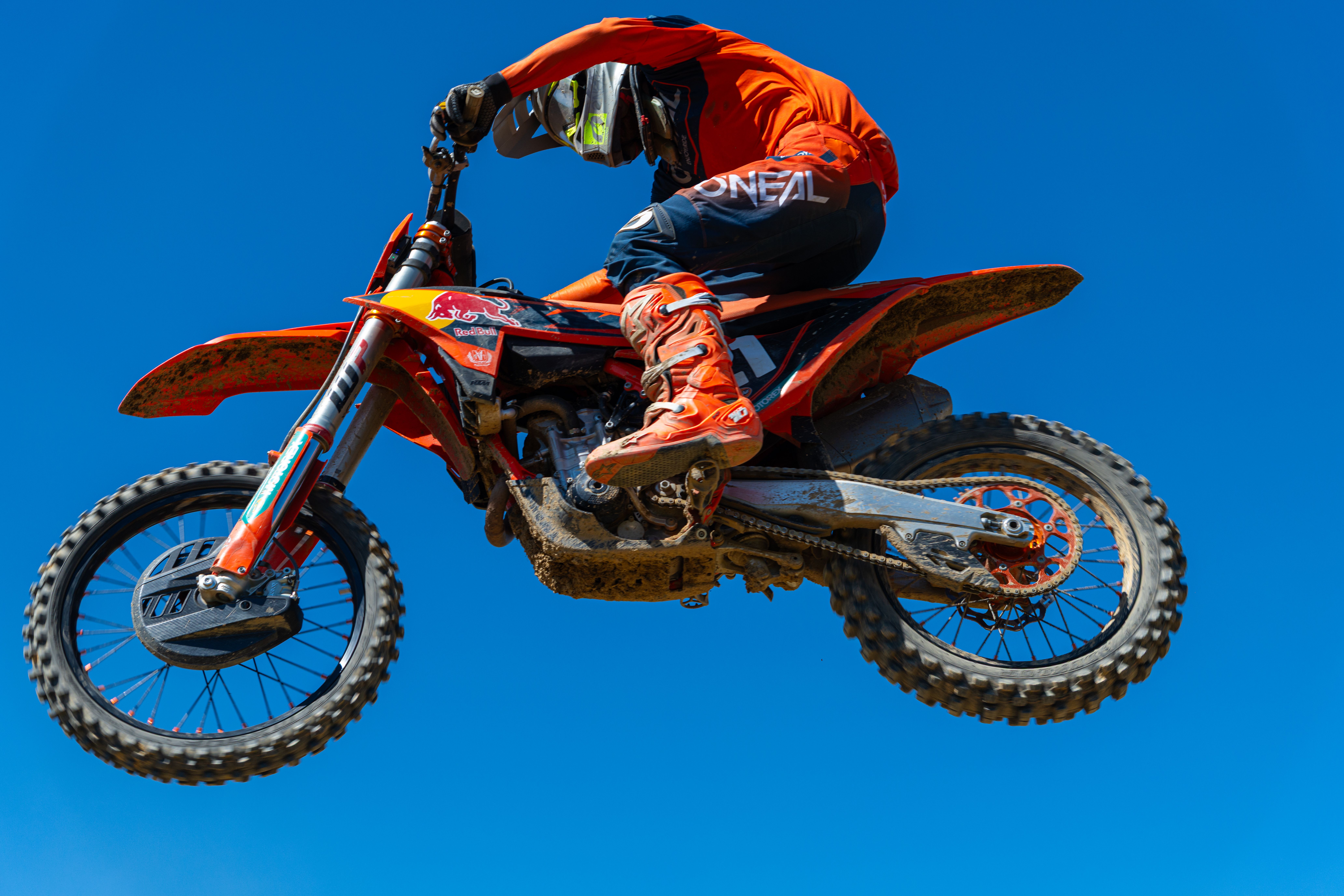 A thrilling capture of a dirt bike rider mid-air on a bright sunny day in Canonsburg.
