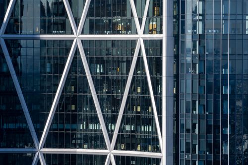 Free Close-up view of a modern skyscraper facade with geometric architectural elements. Stock Photo