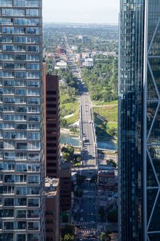 A stunning view of a city street between towering skyscrapers, capturing urban life.