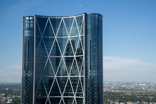 Stunning view of the Bow Tower skyscraper in Calgary under a clear blue sky.