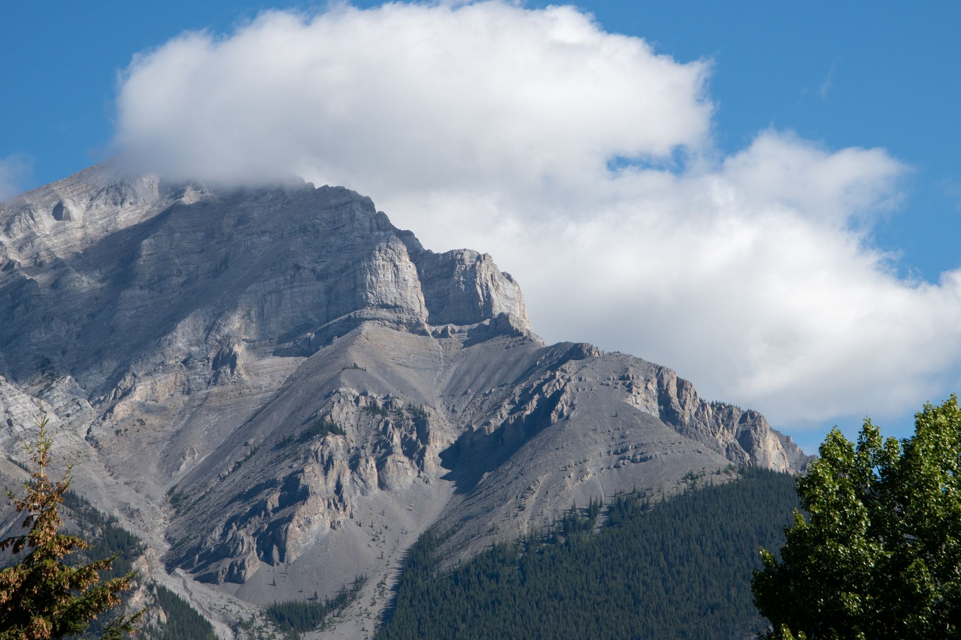 Stunning view of Cascade Mountain under a blue sky in Banff, Alberta, Canada.