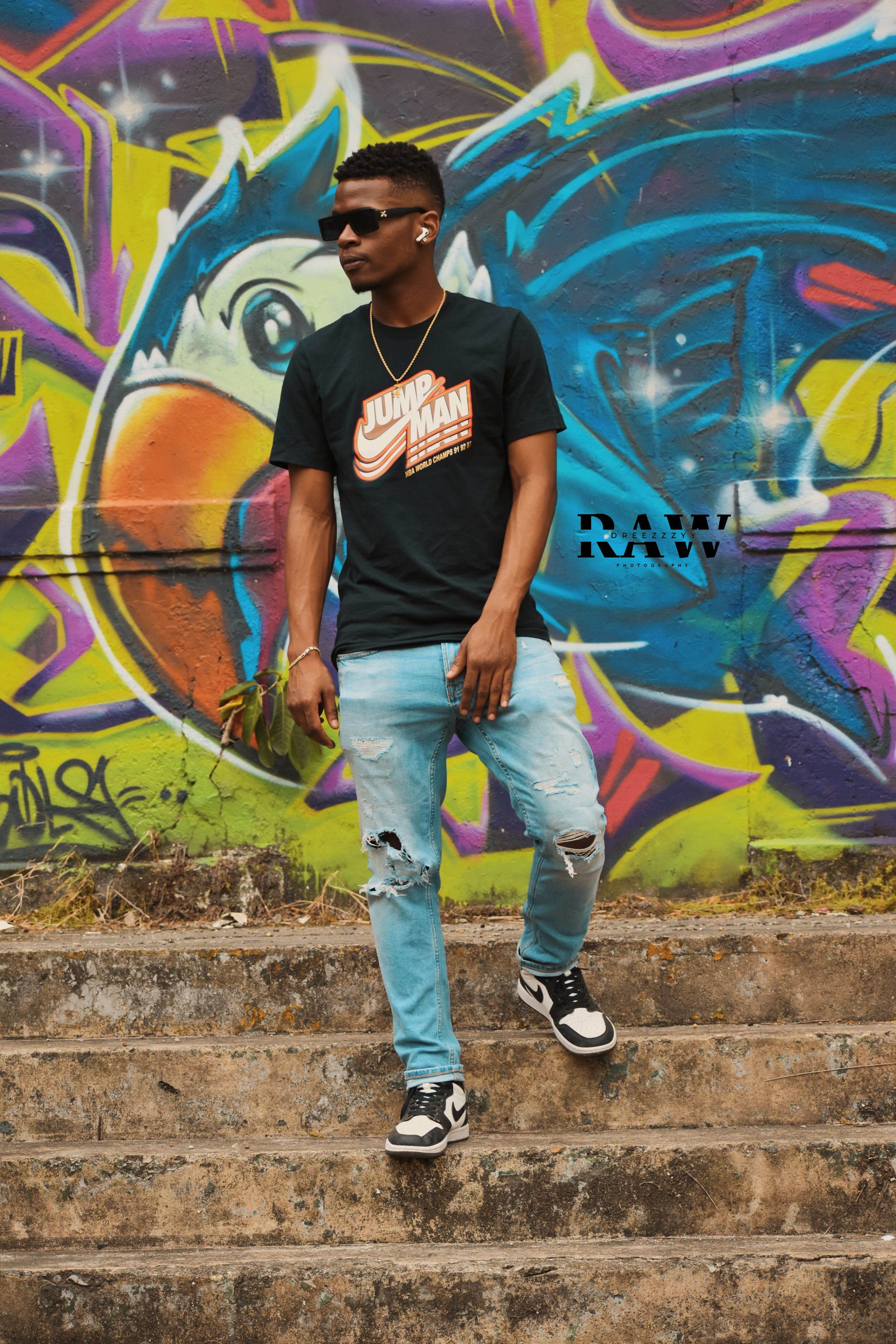 Modern urban street fashion with vibrant graffiti background.