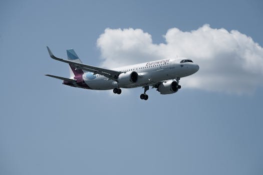 Eurowings Airbus A320 approaching runway with clear sky backdrop.