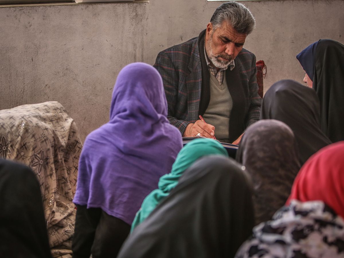 A learning session with Afghan students and a teacher in a classroom