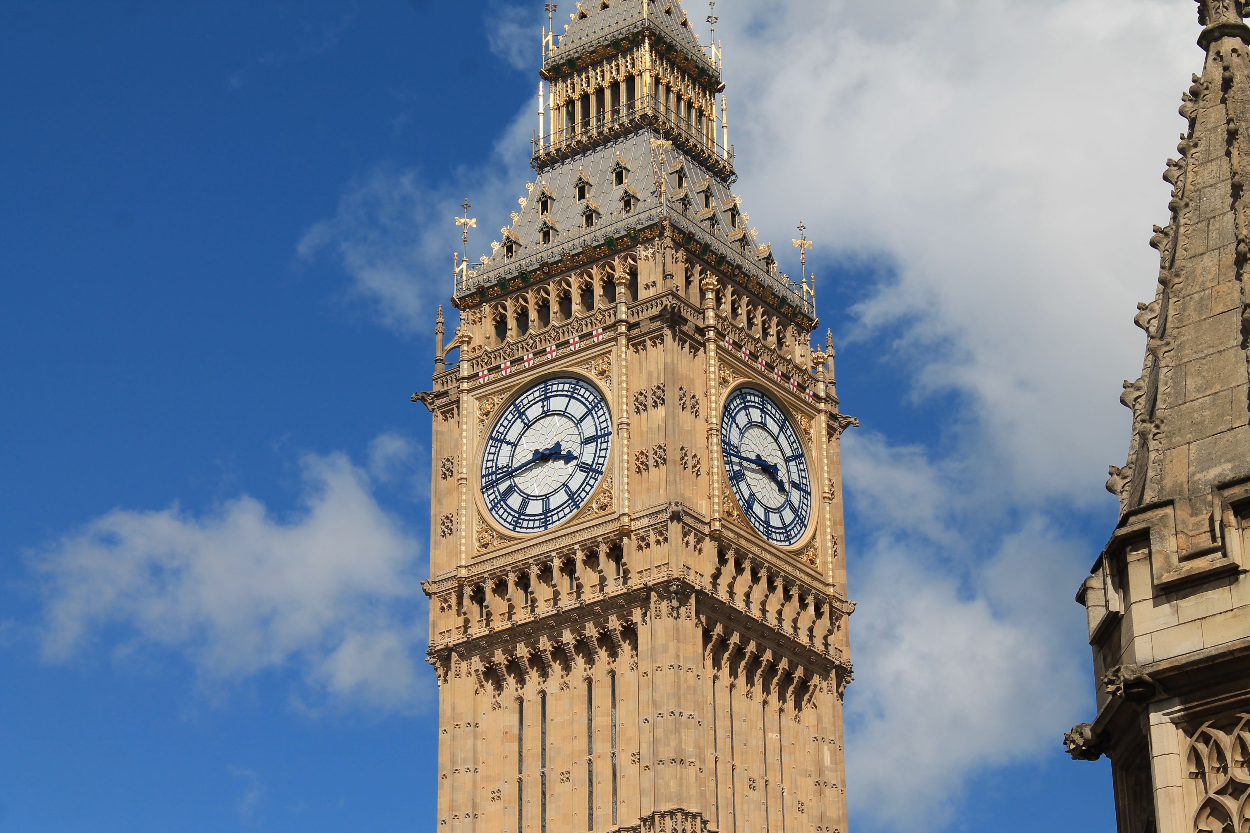 Stunning view of Big Ben against a vibrant blue sky in London, UK.