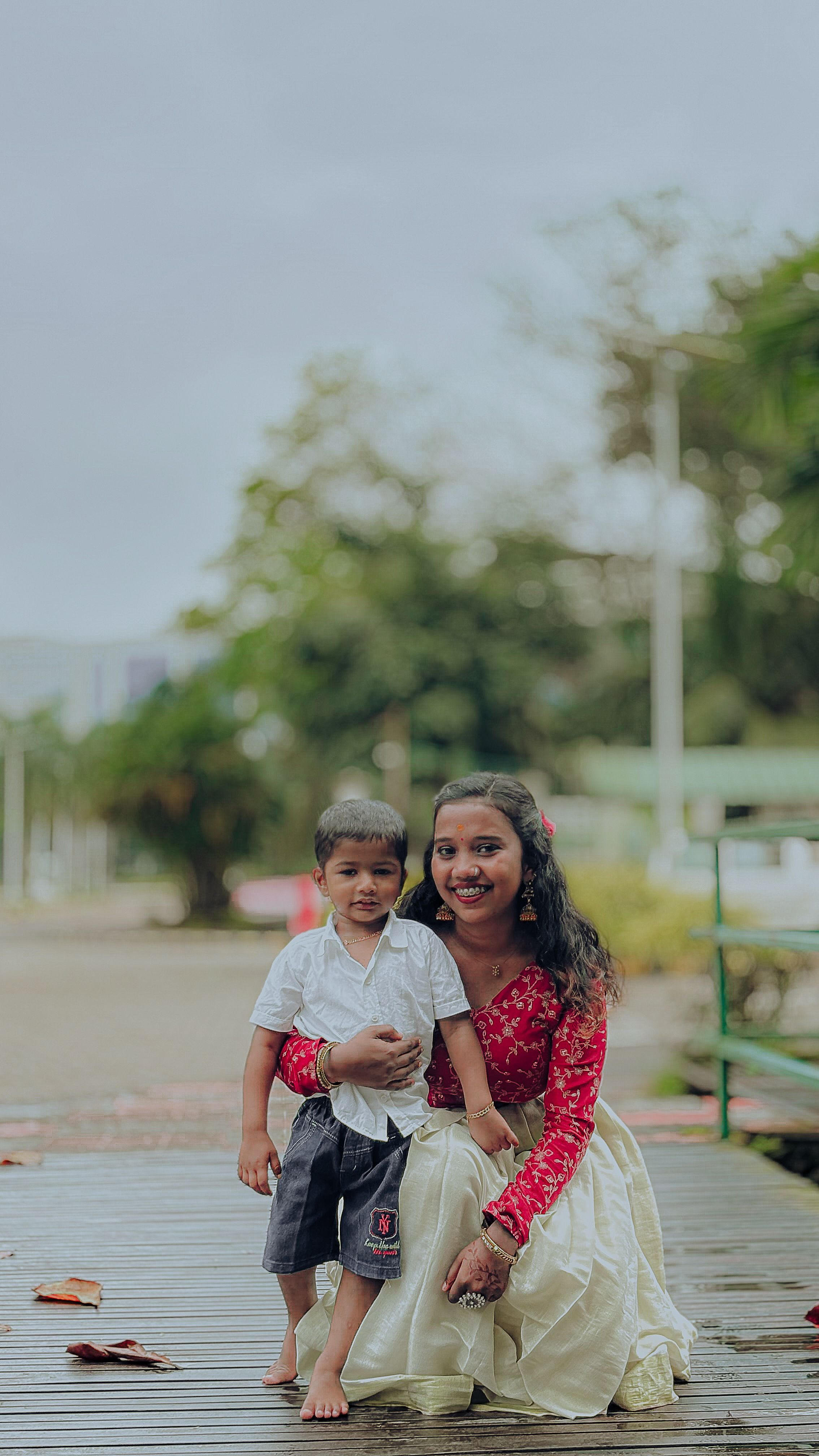 Cheerful mother and son enjoying a day outdoors in Ernakulam, India.