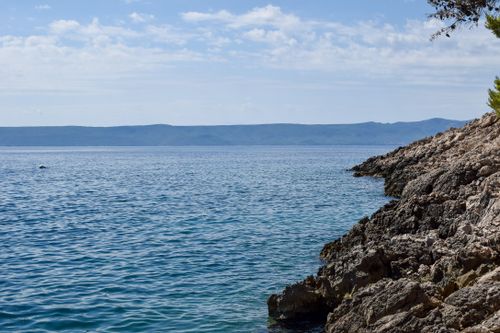 Free Scenic view of the rocky coastline and blue Adriatic Sea in Split-Dalmatia County, Croatia. Stock Photo