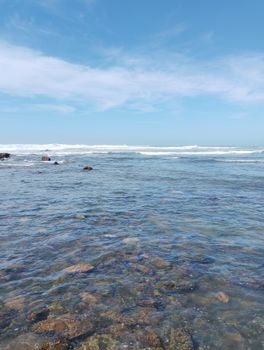 Clear blue waters and rocky shoreline of Casablanca under a bright sky.