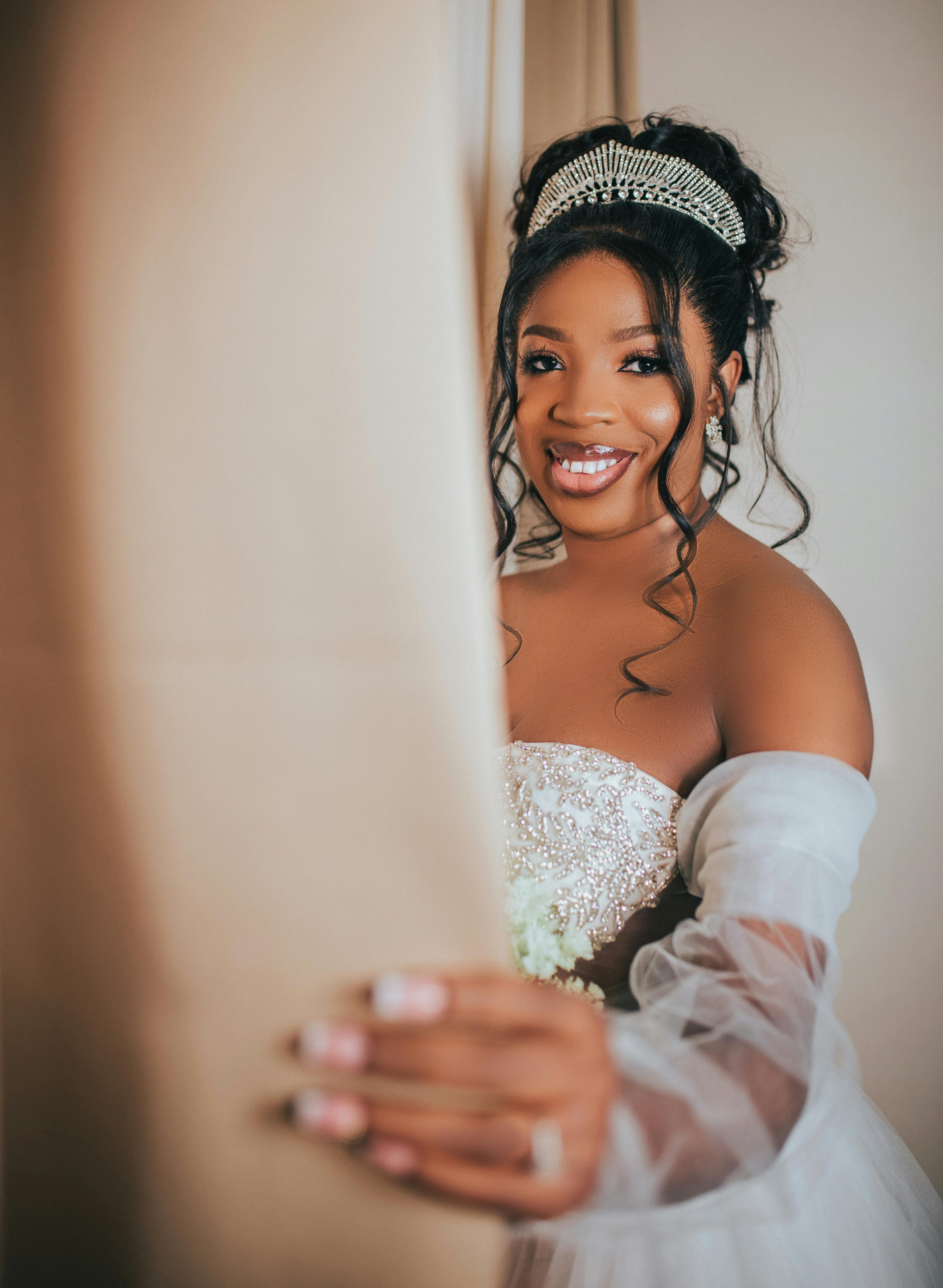 Beautiful black bride in elegant wedding dress with jeweled headpiece smiling