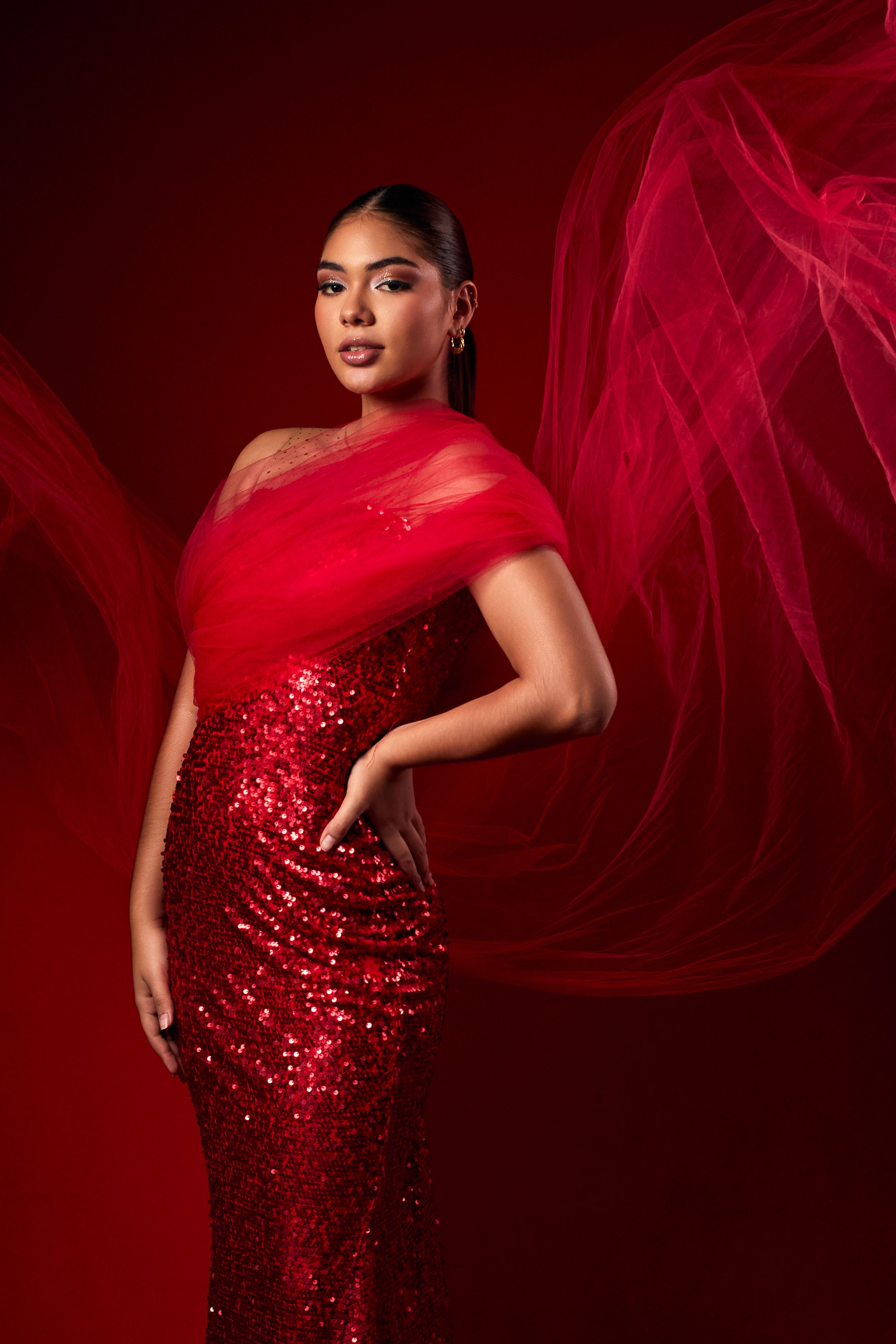 Elegant Woman in Red Sequin Dress with Flowing Fabric · Free Stock Photo