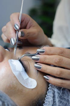 Close-up of a professional eyelash extension procedure in a beauty salon.