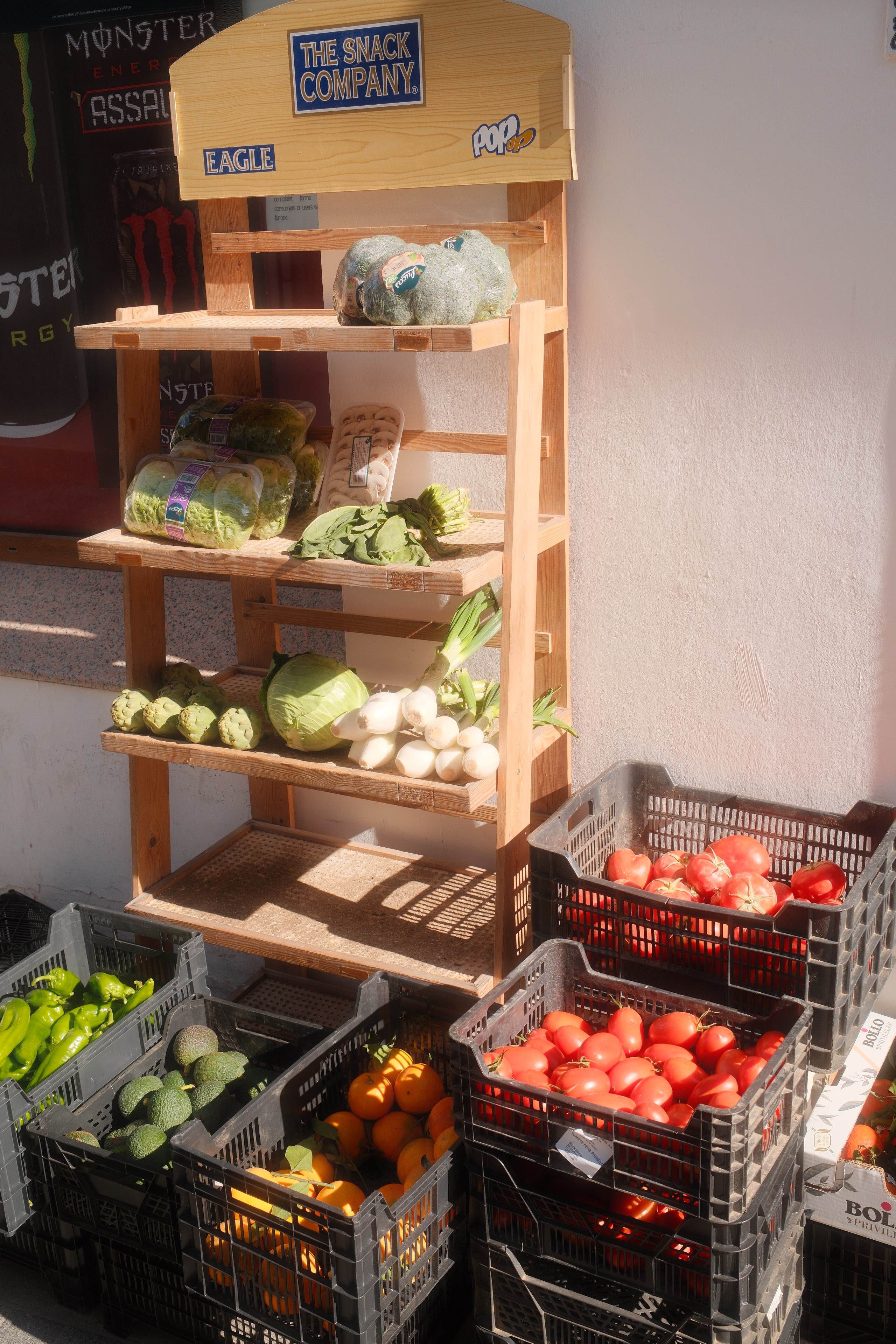 A variety of fresh vegetables on display at a local outdoor market.
