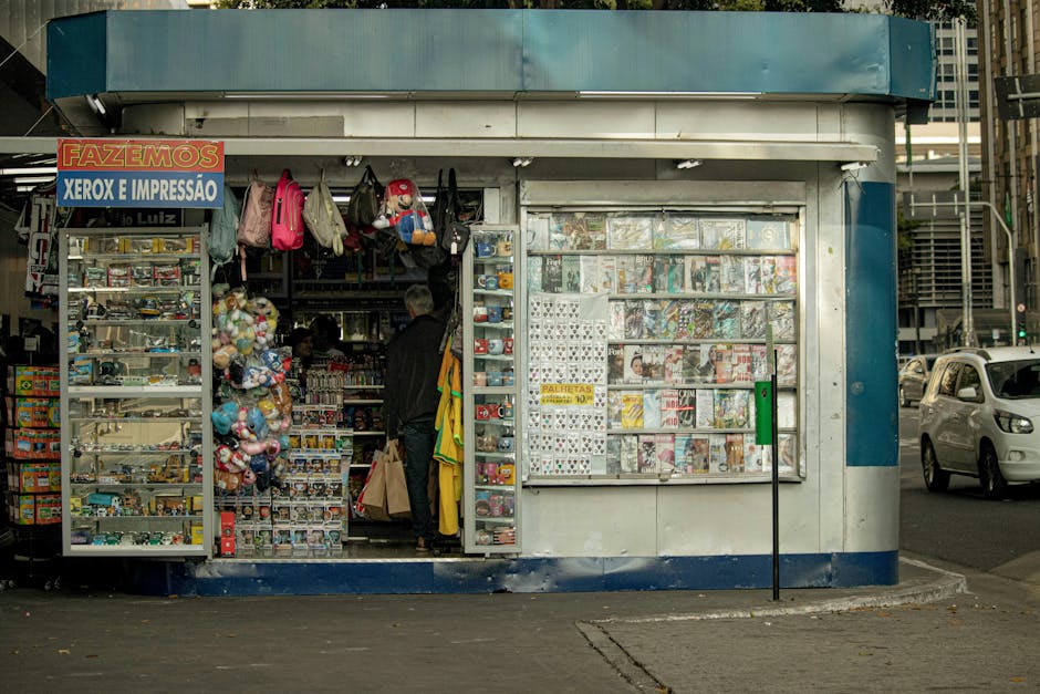 Vibrant newsstand displaying magazines and toys in a bustling city street.